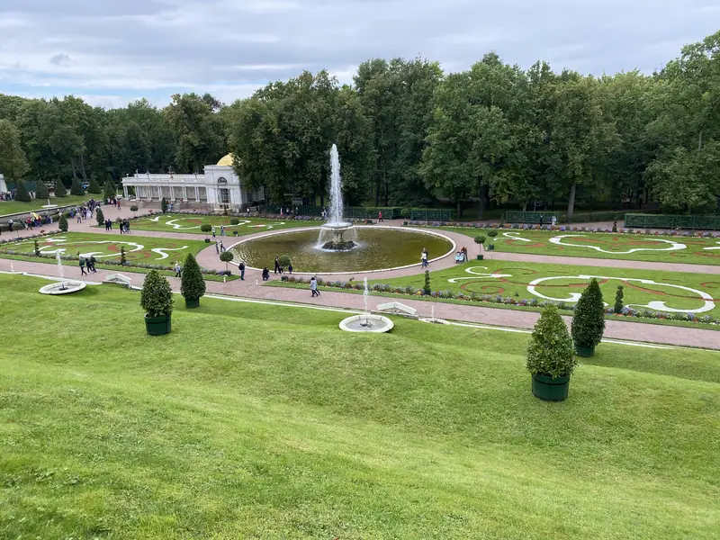 Верхний сад Петергофа сверху: круглый фонтан, узорные партеры с цветами и стриженые кусты в кадках